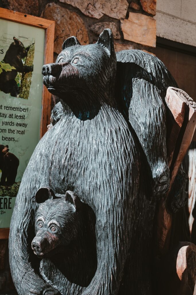 a statue of a bear holding a baby bear