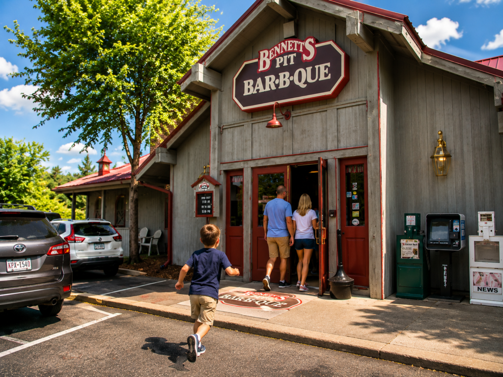 Best Dinner Restaurants in Gatlinburg: Smoky Mountain Favorites Worth the Wait 3 Family arriving at Bennett’s Pit Bar-B-Que in Gatlinburg with a child running toward the entrance on a sunny Smoky Mountain afternoon