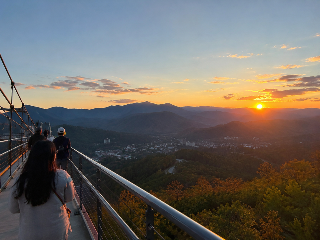 Romantic Restaurants in Gatlinburg: Smoky Mountain Date Nights Worth Slowing Down For 18 Couples walking across the Gatlinburg SkyBridge during sunset overlooking the Smoky Mountains and downtown Gatlinburg
