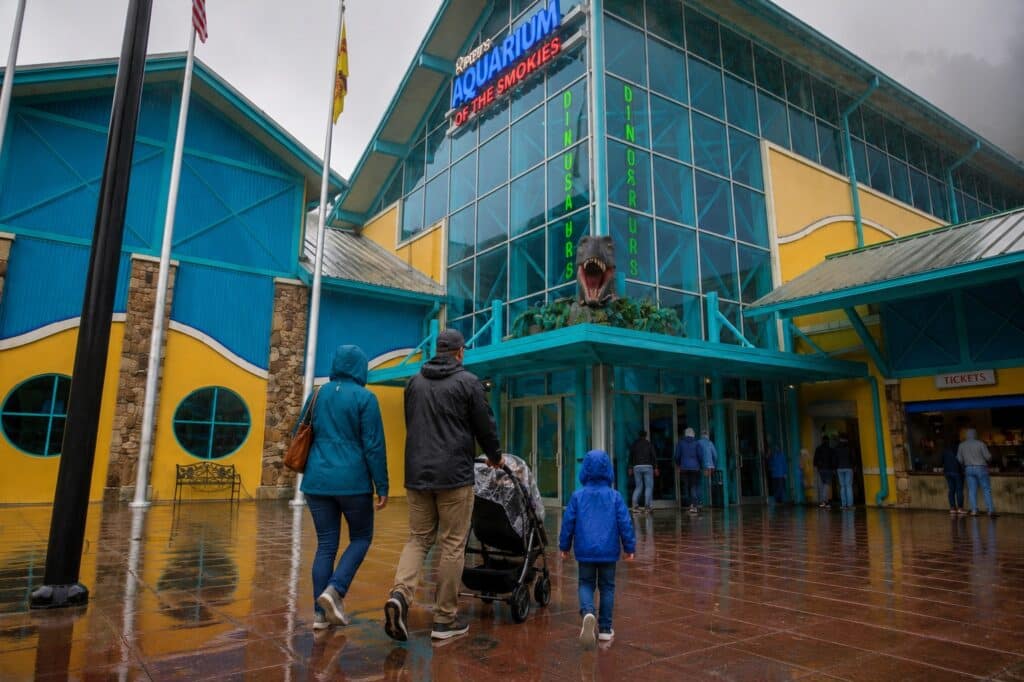 Family walking into Ripley's Aquarium of the Smokies on a rainy day in downtown Gatlinburg, Tennessee one of the main indoor attractions in Gatlinburg.