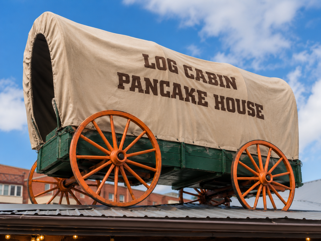 Log Cabin Pancake House Gatlinburg Review: A Local Favorite Hidden Off the Parkway 1 The iconic covered wagon atop Log Cabin Pancake House on Historic Nature Trail in Gatlinburg, Tennessee.