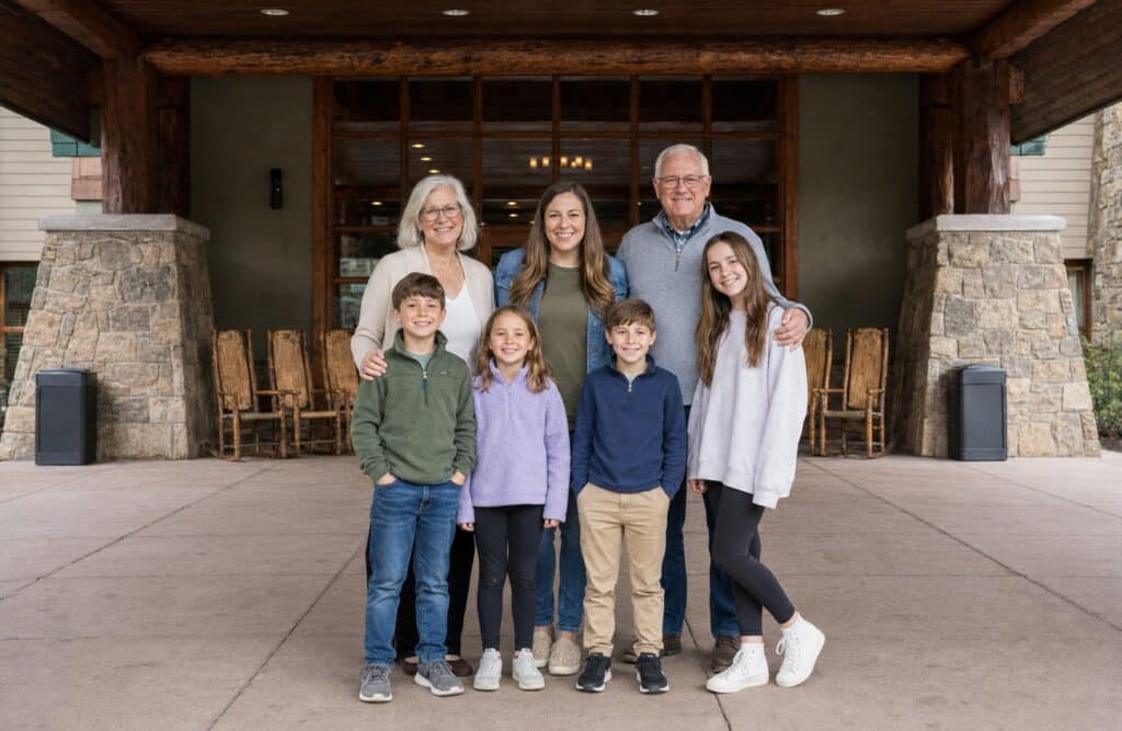 Large family posing together outside the covered entrance to Bearskin Lodge on the River in Gatlinburg