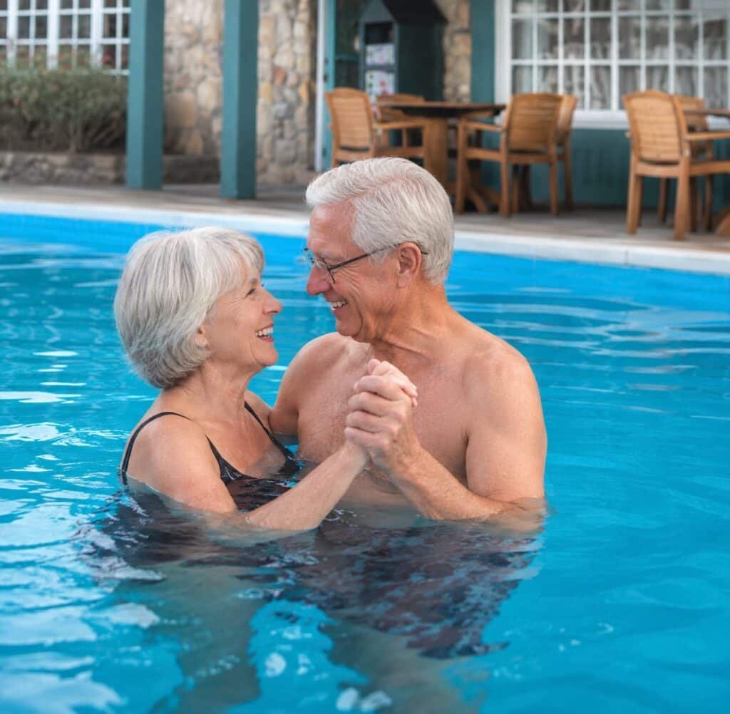 Older couple enjoying the outdoor swimming pool at The Historic Gatlinburg Inn